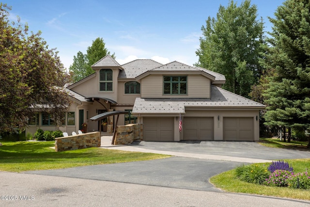 266 Sawatch Dr, Edwards, CO 81632 - french country home featuring a high end roof, driveway, a garage, a front lawn, and stucco siding
