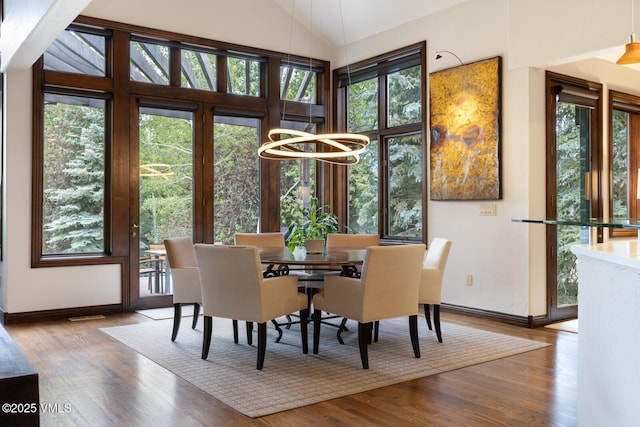 266 Sawatch Dr, Edwards, CO 81632 - dining space with wood finished floors, a chandelier, and lofted ceiling
