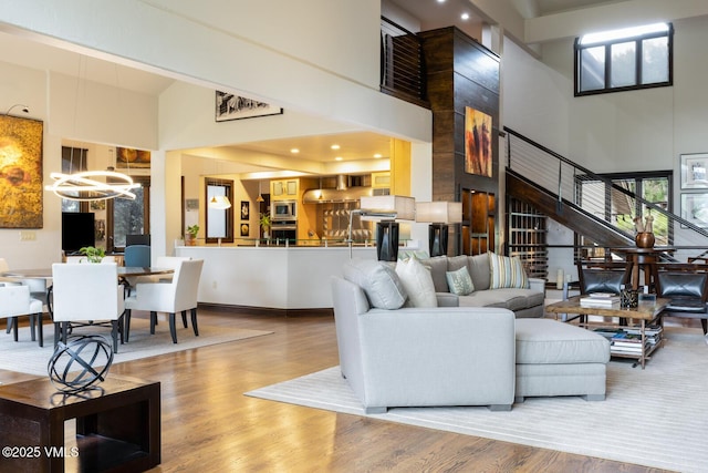 266 Sawatch Dr, Edwards, CO 81632 - living room featuring a high ceiling, stairway, wood finished floors, a chandelier, and recessed lighting