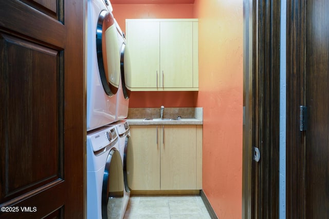 266 Sawatch Dr, Edwards, CO 81632 - laundry area with cabinet space, stacked washer / dryer, and light tile patterned floors