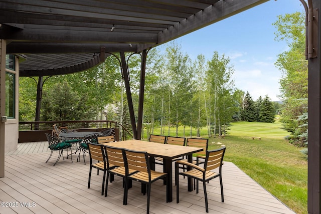 266 Sawatch Dr, Edwards, CO 81632 - wooden deck featuring outdoor dining area, a pergola, a yard, and view of wooded area