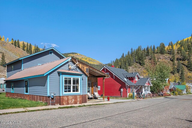 216 Monument St, Red Cliff, CO 81649 - view of front facade featuring a mountain view and a metal roof