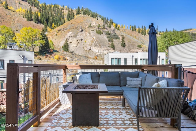 216 Monument St, Red Cliff, CO 81649 - wooden deck featuring an outdoor living space with a fire pit and a mountain view