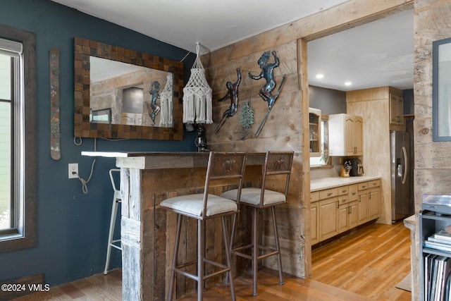 216 Monument St, Red Cliff, CO 81649 - kitchen featuring stainless steel fridge, light wood-type flooring, light countertops, and light brown cabinets