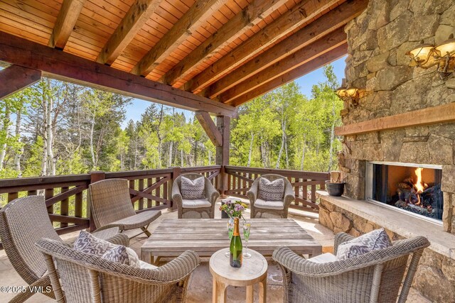 348 Red Draw, Edwards, CO 81632 - wooden terrace featuring view of scattered trees and an outdoor living space with a fireplace