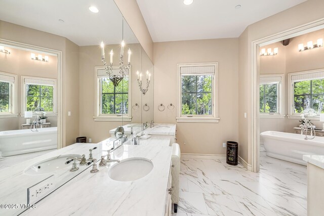 348 Red Draw, Edwards, CO 81632 - bathroom with double vanity, plenty of natural light, baseboards, a freestanding tub, and recessed lighting