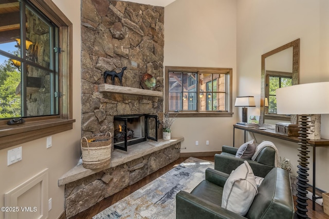 348 Red Draw, Edwards, CO 81632 - living area with wood finished floors, a stone fireplace, and baseboards