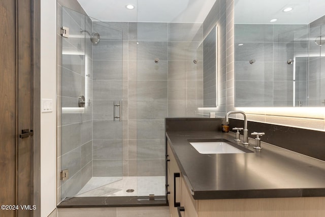 bathroom featuring vanity and a shower with shower door