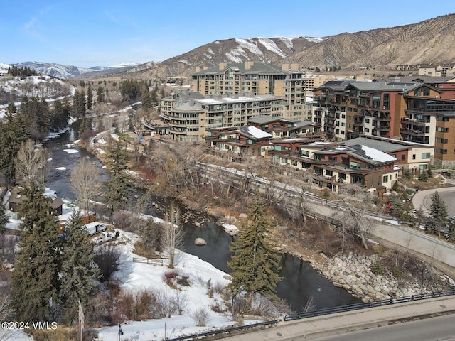 snowy aerial view featuring a mountain view