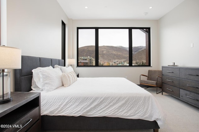 carpeted bedroom featuring a mountain view