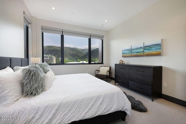 42 Riverfront Ln Unit 507, Avon, CO 81620 - bedroom with light carpet, baseboards, recessed lighting, and a mountain view