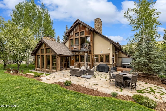 89 Trout Pond Ln, Avon, CO 81620 - rear view of house featuring a chimney, a patio, a balcony, a yard, and stucco siding