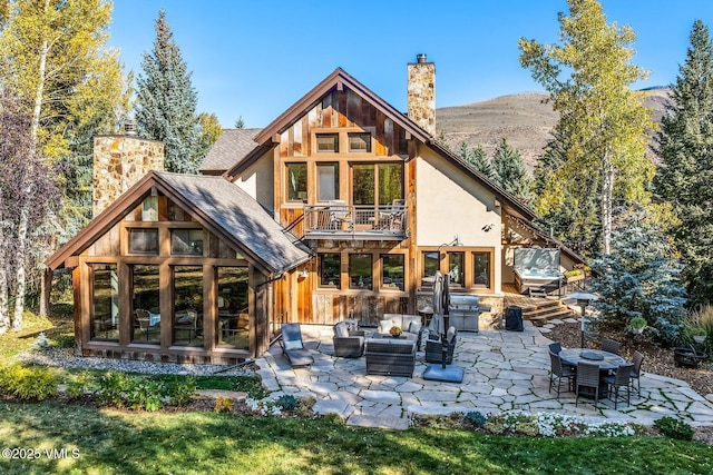 89 Trout Pond Ln, Avon, CO 81620 - rear view of property with a chimney, outdoor lounge area, a patio, a balcony, and roof with shingles
