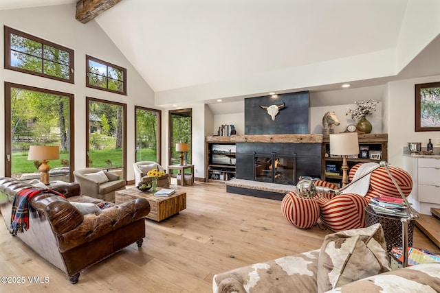 89 Trout Pond Ln, Avon, CO 81620 - living room featuring a large fireplace, high vaulted ceiling, hardwood / wood-style flooring, plenty of natural light, and beam ceiling