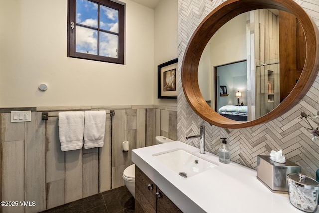 89 Trout Pond Ln, Avon, CO 81620 - ensuite bathroom featuring vanity, wainscoting, and tile walls
