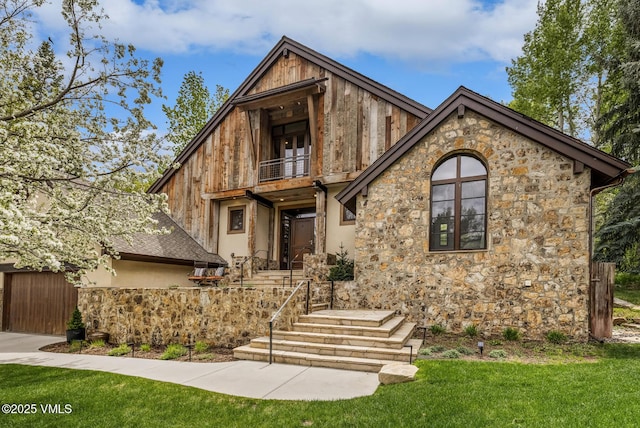 89 Trout Pond Ln, Avon, CO 81620 - view of front of property featuring a balcony, stone siding, and a front lawn