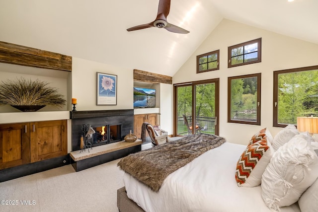 89 Trout Pond Ln, Avon, CO 81620 - carpeted bedroom with access to outside, a warm lit fireplace, high vaulted ceiling, multiple windows, and a ceiling fan