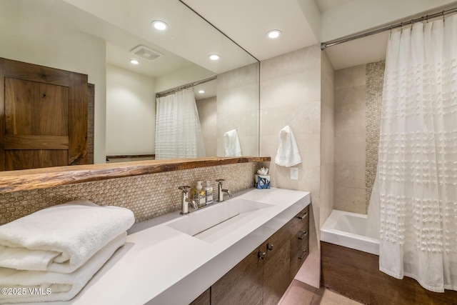 89 Trout Pond Ln, Avon, CO 81620 - full bath with vanity, shower / bath combo, wood finished floors, backsplash, and recessed lighting
