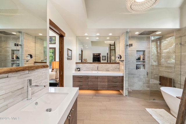 89 Trout Pond Ln, Avon, CO 81620 - bathroom with a shower stall, two vanities, recessed lighting, a freestanding bath, and tile walls