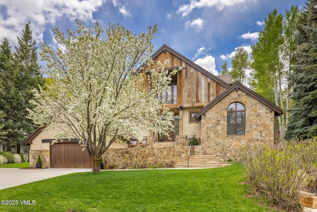 89 Trout Pond Ln, Avon, CO 81620 - view of front of house featuring stone siding, concrete driveway, a front yard, a balcony, and stucco siding