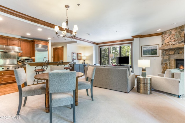 62 Highlands Ln Unit R103, R102, Beaver Creek, CO 81620 - dining area featuring crown molding, a chandelier, recessed lighting, a stone fireplace, and light carpet