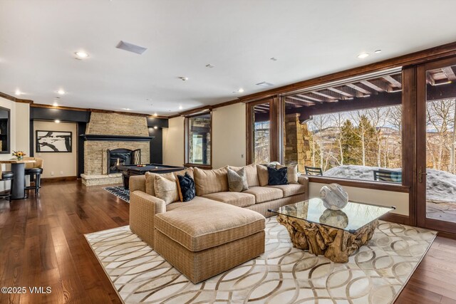 76 Elkhorn, Avon, CO 81620 - living room featuring recessed lighting, ornamental molding, a stone fireplace, and wood finished floors
