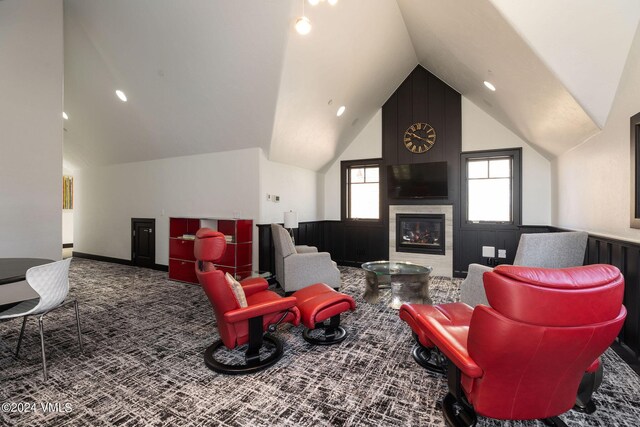 living room featuring lofted ceiling, a tiled fireplace, and carpet flooring