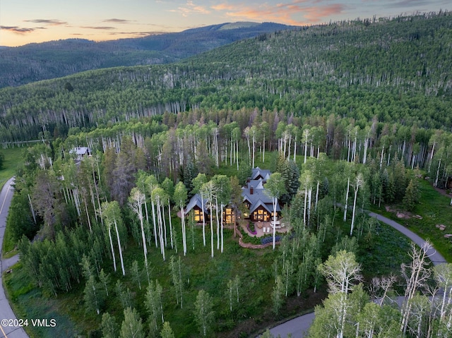 aerial view at dusk featuring a mountain view