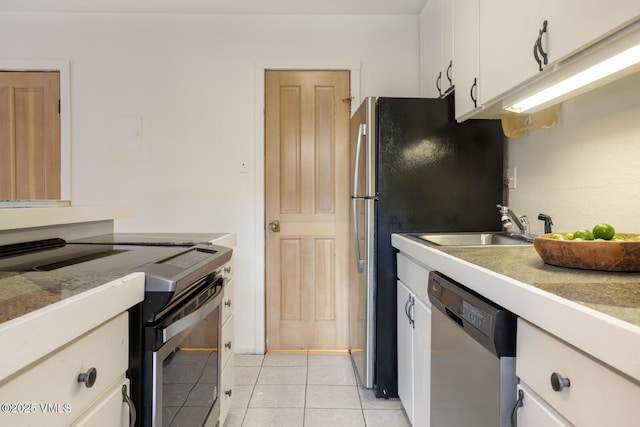 4255 Columbine Way Unit 16, Vail, CO 81657 - kitchen featuring stainless steel appliances, white cabinets, light tile patterned floors, and light countertops