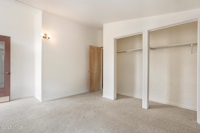 4255 Columbine Way Unit 16, Vail, CO 81657 - unfurnished bedroom featuring two closets, carpet floors, and baseboards