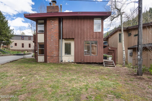 4255 Columbine Way Unit 16, Vail, CO 81657 - back of house with a chimney and a lawn