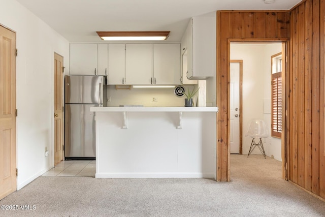 4255 Columbine Way Unit 16, Vail, CO 81657 - kitchen with freestanding refrigerator, light carpet, light countertops, and a breakfast bar area