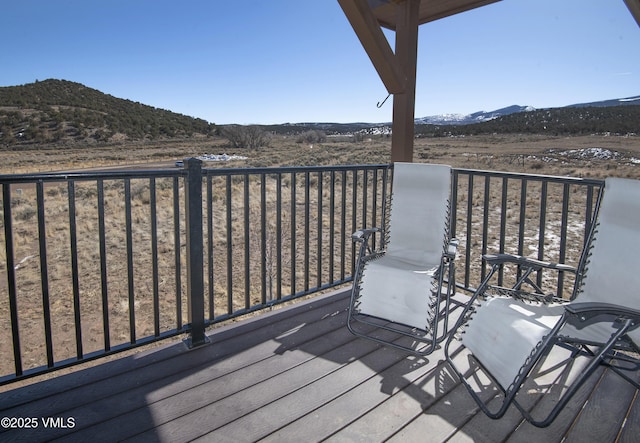 wooden terrace featuring a mountain view