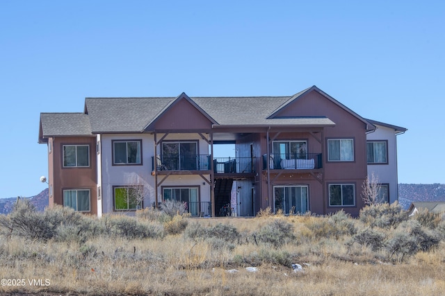 view of property featuring a balcony and stucco siding