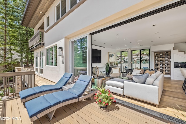 wooden terrace featuring an outdoor hangout area