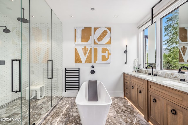 bathroom with vanity and independent shower and bath