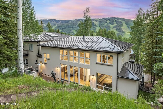 back house at dusk with a mountain view