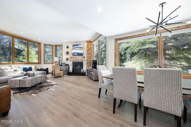 775 Potato Patch Dr Unit E, Vail, CO 81657 - dining room featuring a chandelier, wood finished floors, a stone fireplace, and recessed lighting