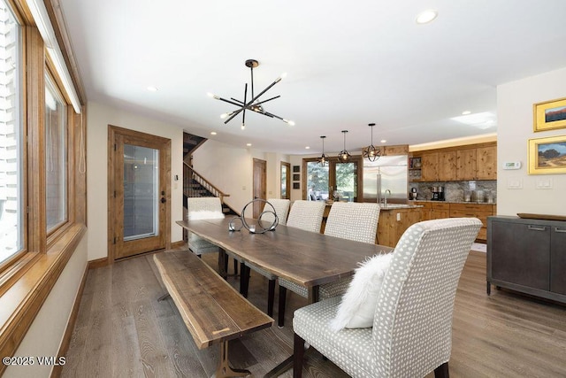 775 Potato Patch Dr Unit E, Vail, CO 81657 - dining room featuring a chandelier, wood finished floors, recessed lighting, and stairway