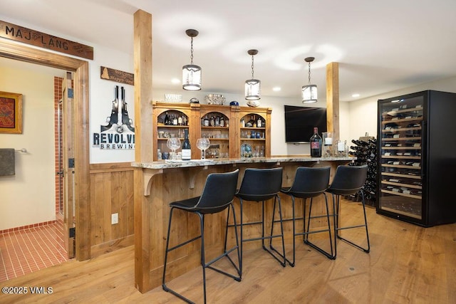 775 Potato Patch Dr Unit E, Vail, CO 81657 - indoor dry bar with wine cooler, light wood finished floors, recessed lighting, and decorative light fixtures