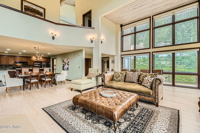 225 Daisy Ln Unit A, Eagle-Vail, CO 81620 - living area with a towering ceiling, a chandelier, light wood-type flooring, and recessed lighting