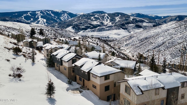 snowy aerial view featuring a mountain view