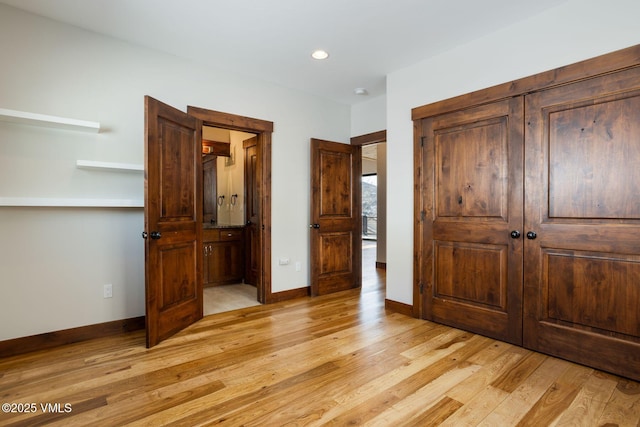 bedroom with light wood-style flooring, baseboards, and recessed lighting