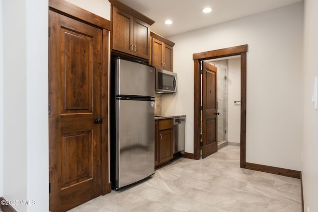 kitchen featuring appliances with stainless steel finishes, recessed lighting, and baseboards