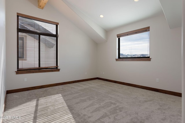 empty room with recessed lighting, light colored carpet, lofted ceiling with beams, and baseboards