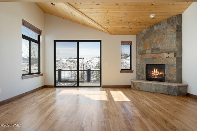 unfurnished living room featuring wooden ceiling, a fireplace, light wood-style flooring, and baseboards