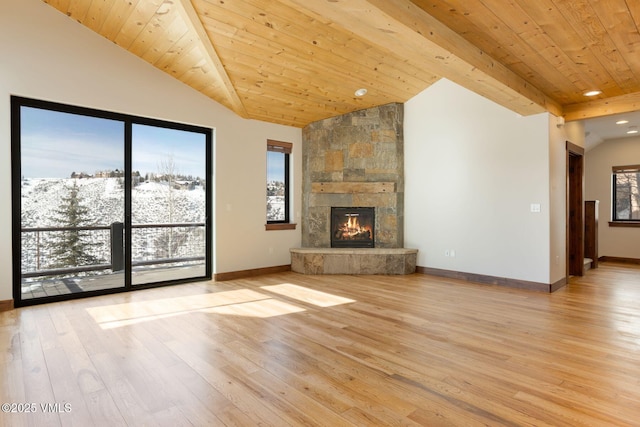 unfurnished living room featuring lofted ceiling, light wood-type flooring, and a fireplace