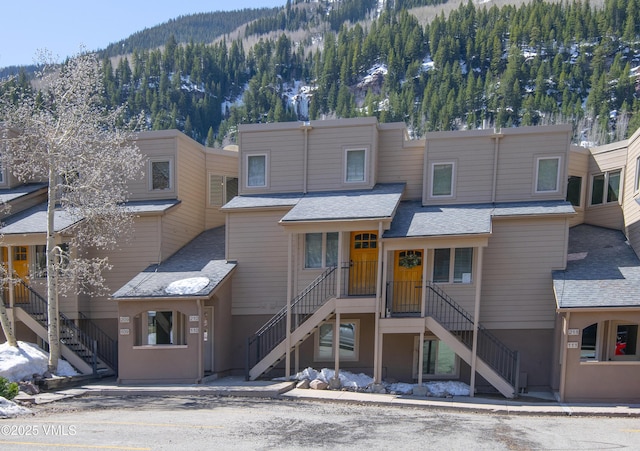 view of property featuring stairway and a mountain view