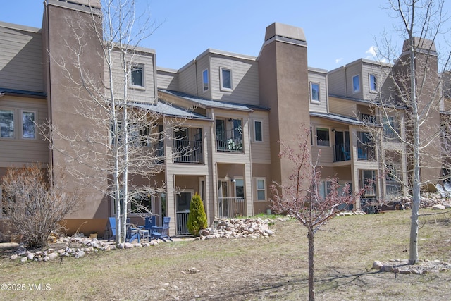 rear view of property featuring a chimney
