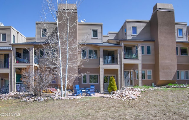 rear view of house featuring a chimney